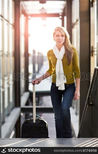 A shot of a beautiful young caucasian woman traveling pulling a luggage