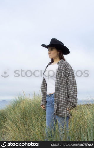 A shot of a beautiful young woman standing and posing outdoor at the beach