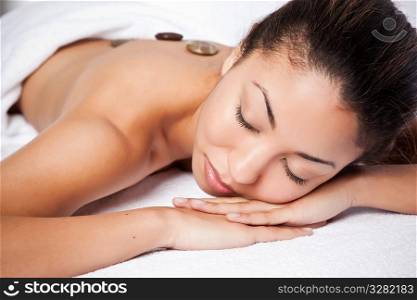 A shot of a black woman lying down at a spa