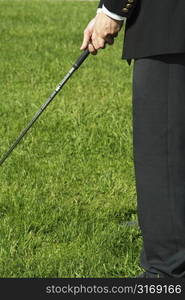 A shot of a businessman playing golf outdoor