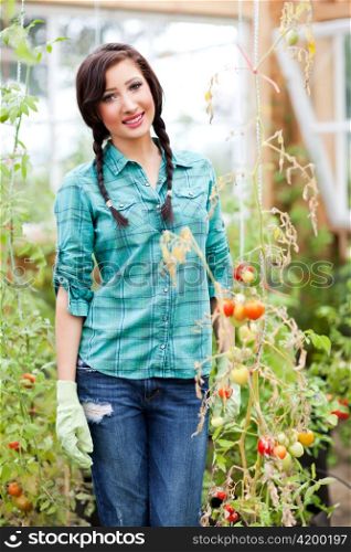A shot of a caucasian woman gardening in the green house