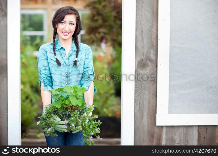 A shot of a caucasian woman gardening in the green house