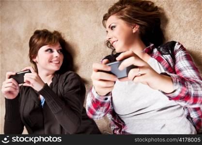 A shot of a couple of teenagers texting messages on their cell phones