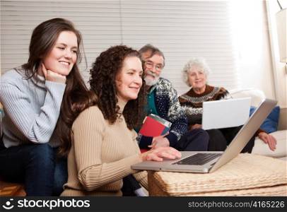 A shot of a family spending time at home with laptop
