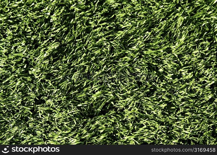 A shot of a green artificial turf on a football field