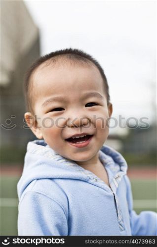 A shot of a happy asian boy laughing