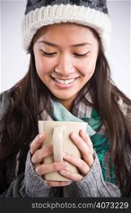 A shot of a happy beautiful asian woman drinking coffee