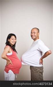 A shot of a happy expecting pregnant asian couple