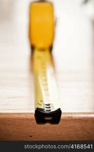 A shot of a measuring tape on a table (shallow DOF)