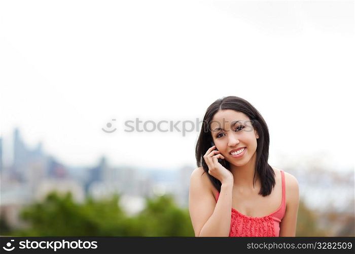 A shot of a mixed race woman talking on the phone