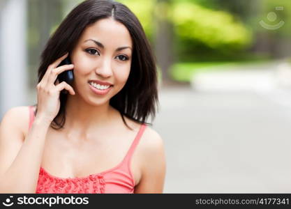 A shot of a mixed race woman talking on the phone