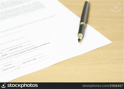 A shot of a paperwork with a pen on a desk