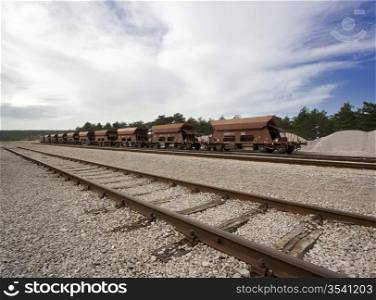 A shot of a railroad station with parked wagons in line.