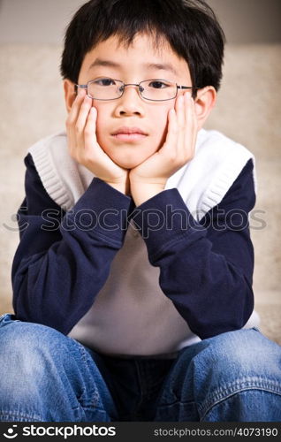 A shot of a sad asian boy