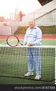 A shot of a senior asian man playing tennis