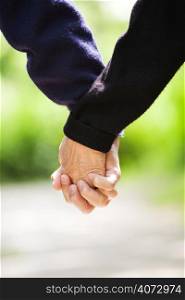 A shot of a senior couple holding hands