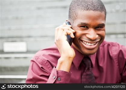 A shot of a smiling black businessman on the phone