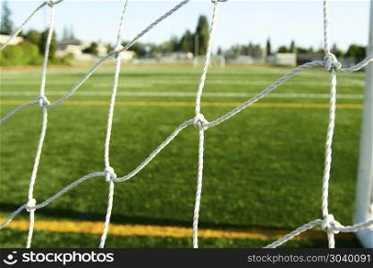 A shot of a soccer field from behind the goal