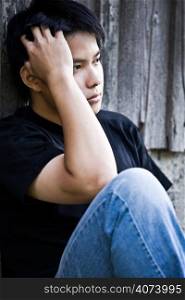 A shot of a stressed asian male outdoor