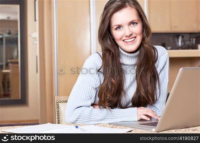 A shot of a teenage girl studying at home with laptop