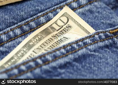 A shot of a ten dollar bill on the back of a blue jeans pocket