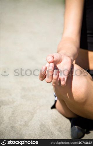 A shot of a woman practicing yoga on the beach