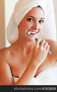 A shot of a young beautiful woman brushing her teeth
