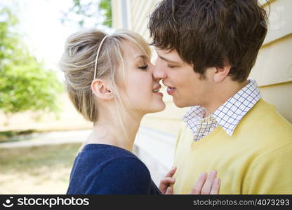 A shot of a young caucasian couple in love kissing outdoor