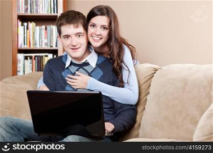 A shot of a young couple working on laptop at home