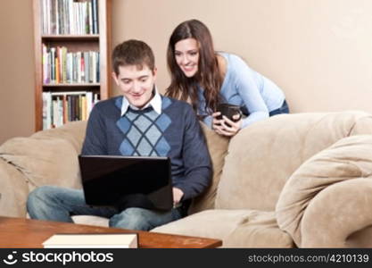 A shot of a young couple working on laptop at home