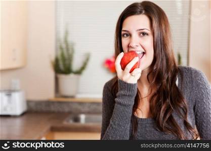 A shot of a young woman eating an apple