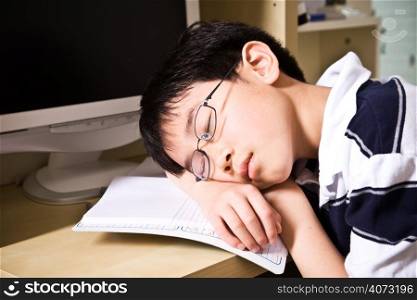 A shot of an asian student falling asleep while studying at home
