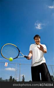 A shot of an asian tennis player hitting a tennis ball
