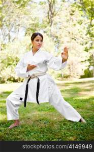 A shot of an asian woman practicing karate