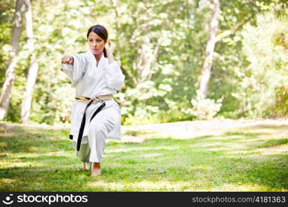 A shot of an asian woman practicing karate