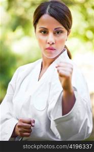 A shot of an asian woman practicing karate