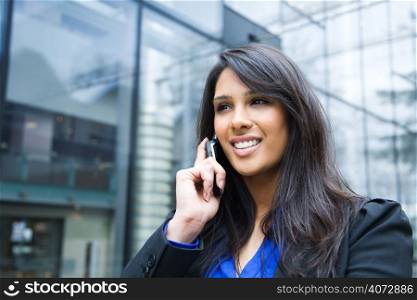 A shot of an indian businesswoman talking on the phone outdoor