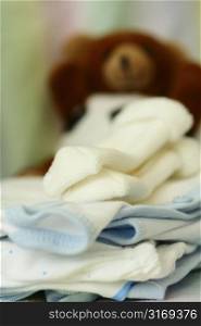 A shot of baby clothing and doll in a nursery