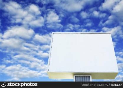 A shot of blank billboard against a cloudy blue sky