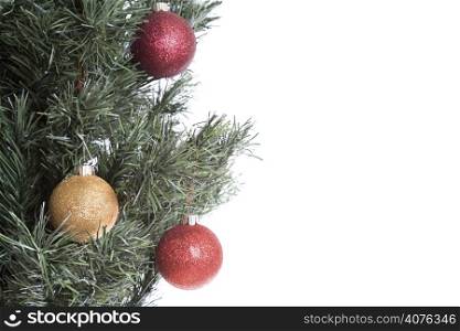 A shot of christmas tree with hanging ornaments with plenty of copyspace