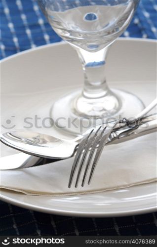 A shot of dining table with silverware and napkins