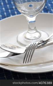 A shot of dining table with silverware and napkins