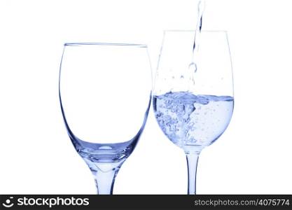 A shot of drinking water poured into a glass