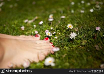 A shot of feet of a woman standing on the grass
