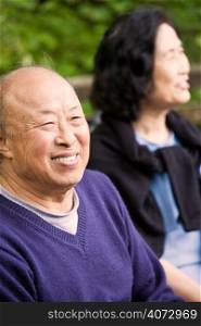 A shot of happy elderly asian couple outdoor