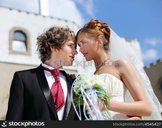 A shot young couples entering into marriage. Portrait of bride and groom in nature.