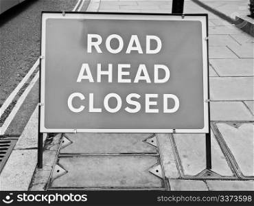 A sign. A traffic or a construction site sign - Road ahead closed
