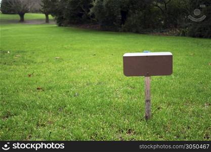 A sign on a grass field