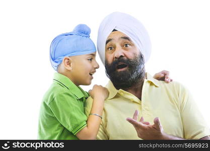 A Sikh boy talking to his grandfather