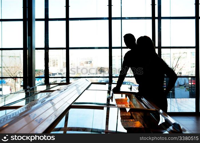 A silhouette of a couple in a trendy supermarket